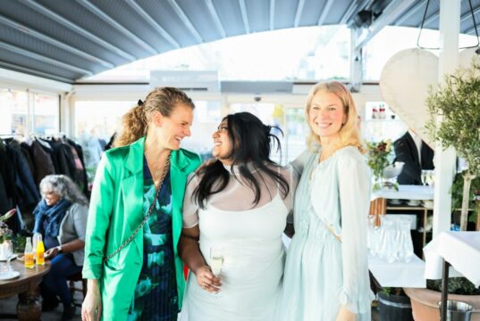 How to Practice Body Positivity When You’re Plus Size: Confidence Tips for Every Outfit Three How to Practice Body Positivity When You’re Plus Size: Confidence Tips for Every Outfit smiling and talking at an outdoor event